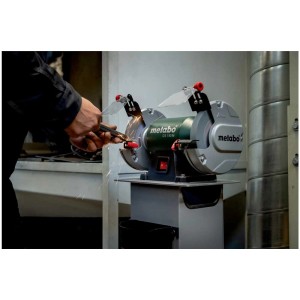Meuleuse d'établi Metabo DS 150 M affûtant une pièce avec protection anti-étincelles.