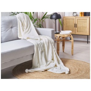 Coperta Beliani Kaweri color crema in poliestere con pon pon su divano, 150x200 cm.
