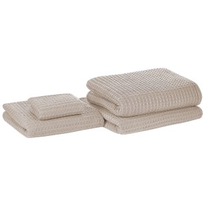 Ensemble de 4 serviettes de bain Areora en coton beige avec texture gaufrée.