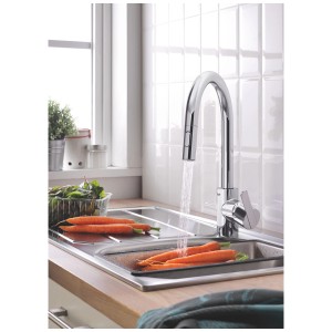 Miscelatore cucina Grohe Feel con doccetta estraibile, cromo, installato in lavello con verdure.