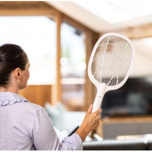 Femme tenant une tapette à mouches électrique 2 en 1 Windhager à l'intérieur.