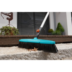 Scopa stradale Gardena Combisystem con spazzola blu e bordo raschiante per rimuovere lo sporco.