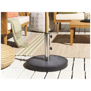 Support de parasol Beliani Ceggia en granit noir, Ø 45 cm, sur terrasse.