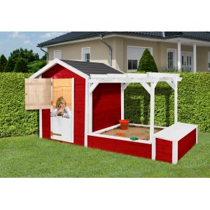Cabane de jeux Weka Drachenhöhle Tabaluga rouge et blanc avec bac à sable et pergola, enfant regardant par la fenêtre.