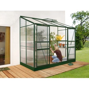 Serra addossata Vitavia Ida 3300 verde con pannelli alveolari contro muro con persona.