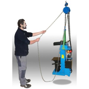 Palan à chaîne Güde 2000 kg en utilisation, actionné par une personne. Idéal pour soulever des charges lourdes.