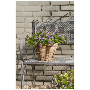 Cesto rotondo grigio Mica Decorations Marcia (Ø 29 cm) con piante fiorite viola su una panchina.