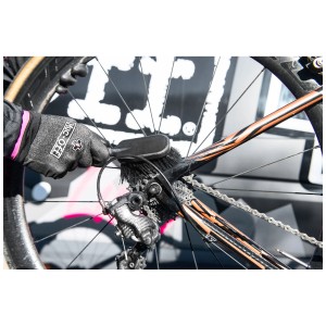 Muc-Off Reinigungsbürste für Reifen und Kassette im Einsatz am Fahrrad.