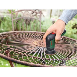 Spazzola a batteria Bosch Universal Brush in uso per pulire un tavolo da giardino.