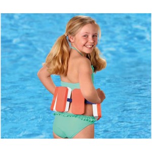 Bambina con ausilio al galleggiamento Bema (30-60 kg) in acqua, galleggianti arancioni con cinturino.
