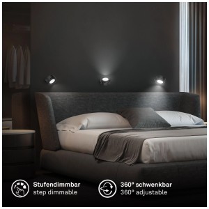Spots muraux à batterie noirs Briloner Tari au-dessus d'un lit. Lampe murale LED avec variateur tactile et support magnétique.
