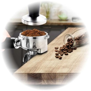 Macchina da espresso Barista Plus argento con chicchi di caffè e pressino su tavola di legno.