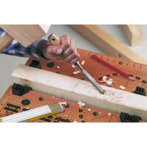 Ciseau à bois LUX Comfort 20 mm en utilisation : Artisan travaillant le bois avec ciseau et marteau.