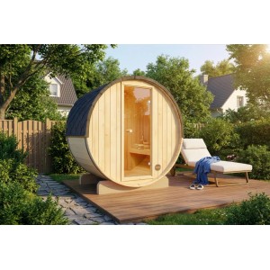 Sauna tonneau en bois FinnTherm Mini XXS avec porte en verre et chaise longue dans le jardin.