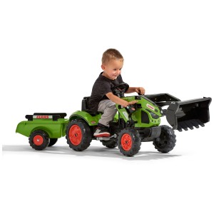 Trattore Falk Claas con rimorchio e caricatore frontale, giocato da un bambino. Trattore a pedali verde per bambini dai 2 ai 5 anni.
