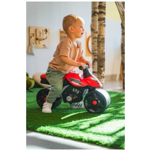 Bambino su cavalcabile Falk Motobike Racing rosso. Promuove le capacità motorie e l'equilibrio.