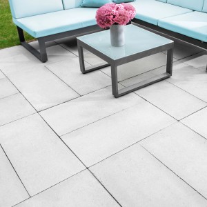Piastre per pavimentazione Diephaus grigio cemento 60x40 cm su terrazza con mobili.
