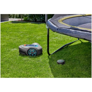 Trasmettitore di segnale Gardena ZoneProtect con robot tagliaerba Sileno su prato sotto il trampolino.