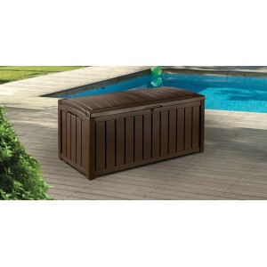 Coffre de rangement coussins Keter Glendwood marron près de la piscine, idéal pour les coussins de jardin.
