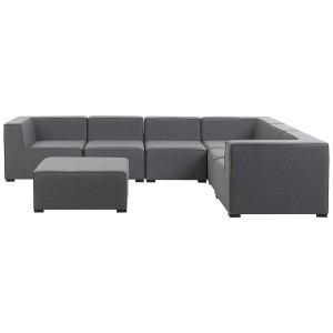 Ensemble lounge gris Beliani Arezzo, canapé modulable 7 places avec pouf pour jardin ou terrasse.