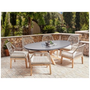 Ensemble de jardin Beliani Oristano: table ovale en fibrociment, 6 chaises tressées avec cadre en acacia et coussins.