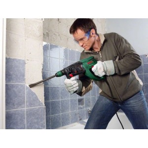 Uomo che lavora con un martello perforatore Bosch PBH 3000-2 FRE su una parete.