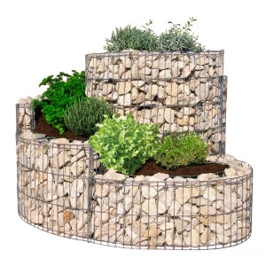 Petite spirale à herbes aromatiques en gabion plantée d'herbes, gabion en pierre comme potager surélevé.