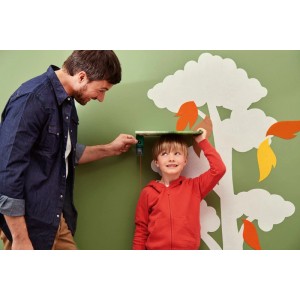 Mann misst Kindergröße mit Bosch Laser-Entfernungsmesser PLM30-21 an Wand. Präzises Prüfwerkzeug für Messungen.