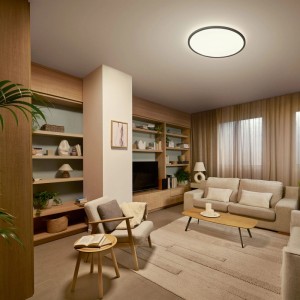 Plafonnier LED Philips Valen, noir, 55 cm, rond, éclairant chaleureusement un salon moderne.