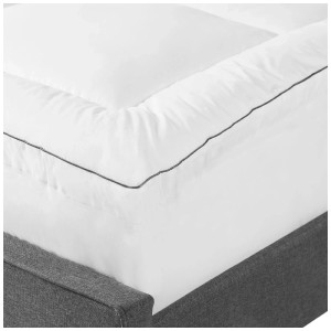 Topper per materasso Beliani bianco 90x200 cm in cotone Japara su un letto.