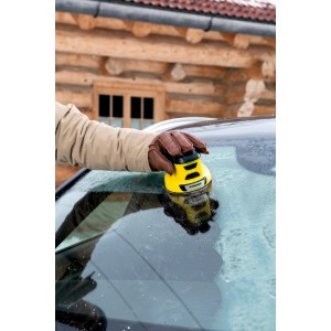 Grattoir à glace électrique sans fil Kärcher EDI 4 jaune en utilisation sur un pare-brise de voiture gelé.