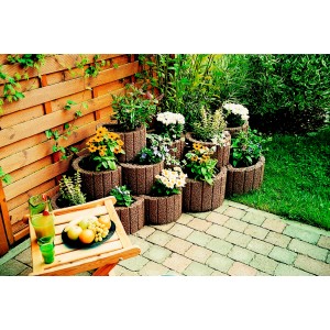 Anneaux de plantation bruns petits 35 cm x 20 cm empilés et plantés dans le jardin.