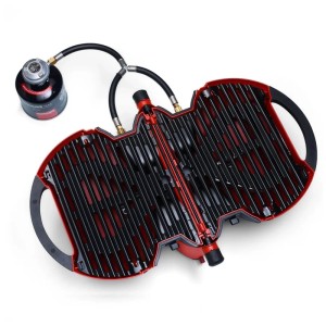 Nomadiq Gasgrill Modell 3.0 Terra-Rot, geöffnet mit Gasflasche. Kompakter, tragbarer Grill.