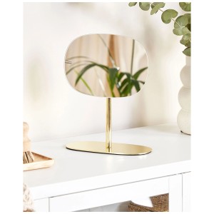Specchio cosmetico Charente dorato con design senza cornice su un tavolo bianco.