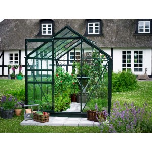 Serre verte Halls Popular 106 avec des plantes devant une maison.