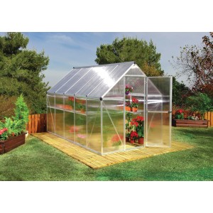 Copertura per patio Palram Canopia Feria bianca 3x5.46 con porta aperta e piante.