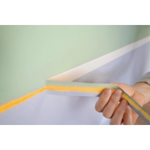 Application du Tesa Malerband Perfect+ (19mm) sur un mur pour des bords de peinture précis.