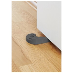 Cuneo ferma porta Multi-Stop® antracite in plastica blocca una porta bianca su pavimento in legno chiaro.