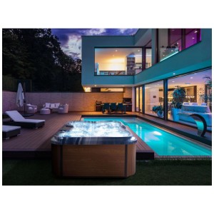 Jacuzzi extérieur Beliani Arcelia avec éclairage LED bleu sur terrasse en bois près de la piscine. Design moderne pour 4 personnes.