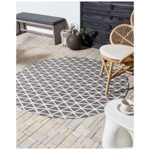 Runder Outdoor-Teppich Panaji, grau-weiß mit geometrischem Dreiecksmuster, aus Polypropylen, Ø 160 cm, auf Terrasse.