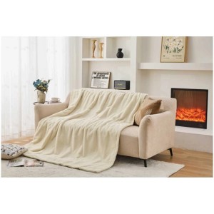 Coperta termica beige Sonnenkönig Emmy in pile (180x130 cm) su divano.