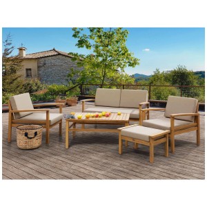 Set lounge Beliani Manila 4 posti in legno di acacia con tavolo e cuscini in giardino.