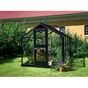 Serra Juliana Compact 6, antracite, con piante in giardino.