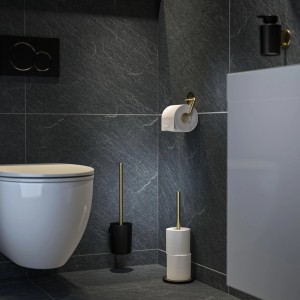 Porte-rouleau de réserve sur pied Tiger Tune en laiton brossé et noir dans une salle de bain.