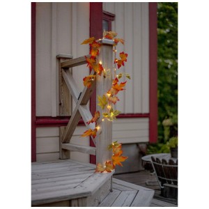 Figura LED Star Trading Esther con foglie colorate e luce bianca calda come decorazione.