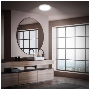 Plafonnier LED rond Briloner Pulap chromé avec effet rétroéclairage dans une salle de bain moderne.