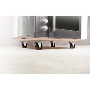 Planche de transport rectangulaire TE-200 B avec roulettes sous un four sur moquette.