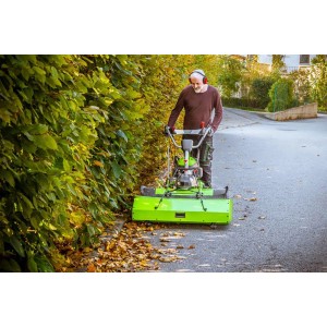 Homme utilisant une balayeuse Zipper ZI-KM1000 avec lame à neige pour balayer les feuilles.