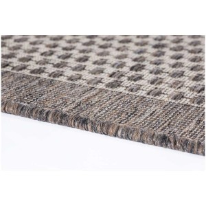 Gros plan du tapis marron Andiamo Savannah 120x170 cm avec motif à pois.