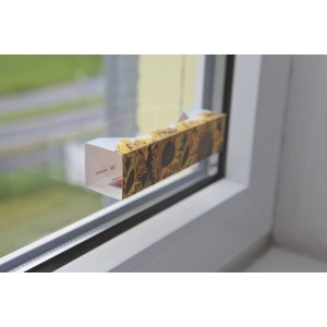 Trappola per mosche da finestra Windhager con motivo a girasole sul telaio.